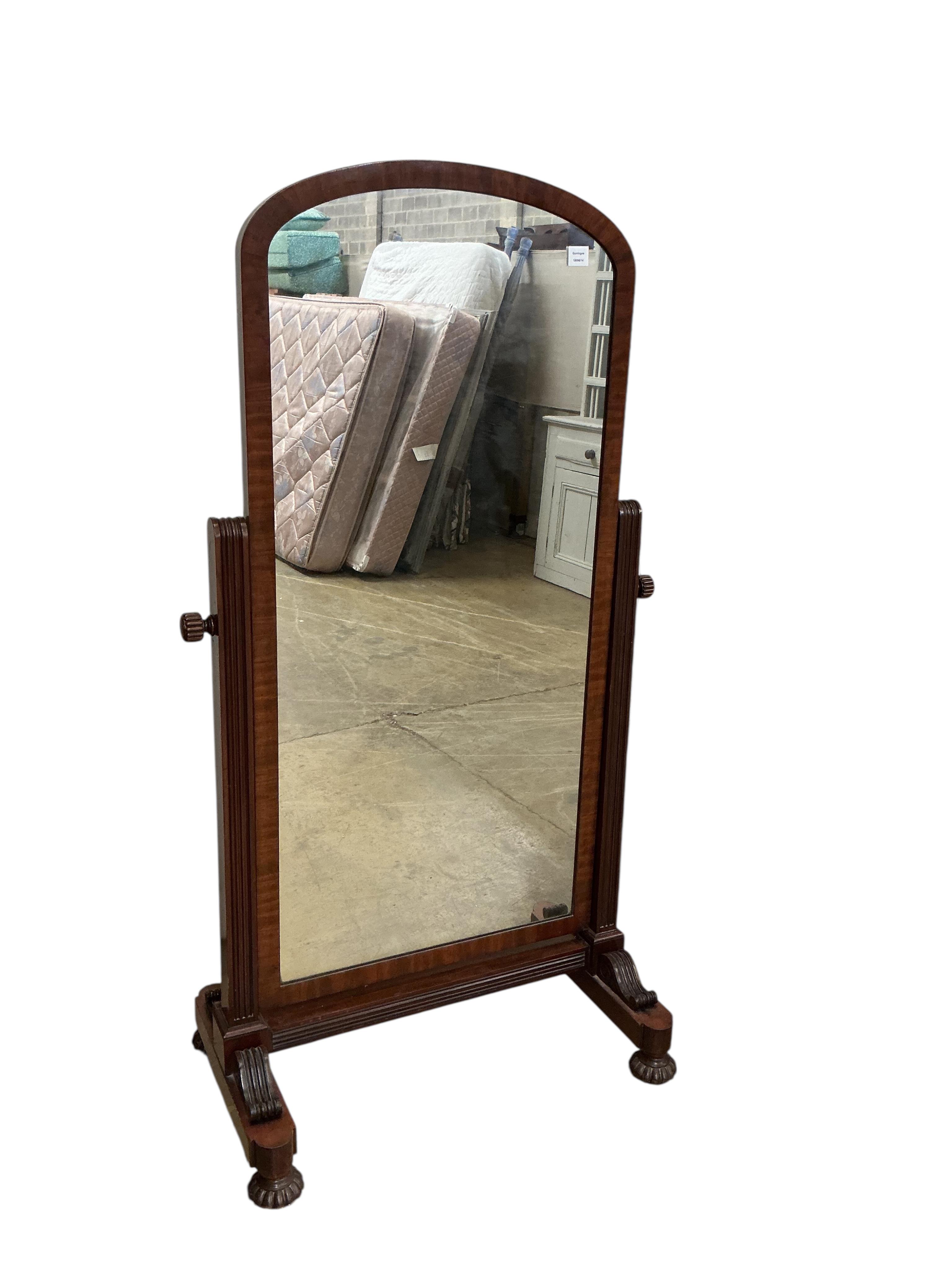 A Victorian mahogany cheval mirror, with arched plated and fluted bun feet, width 92cm, height 170cm